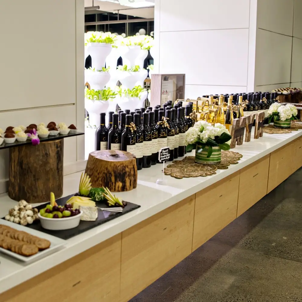 A long counter filled with an array of delicious food and bottles of wine, creating a festive dining atmosphere.